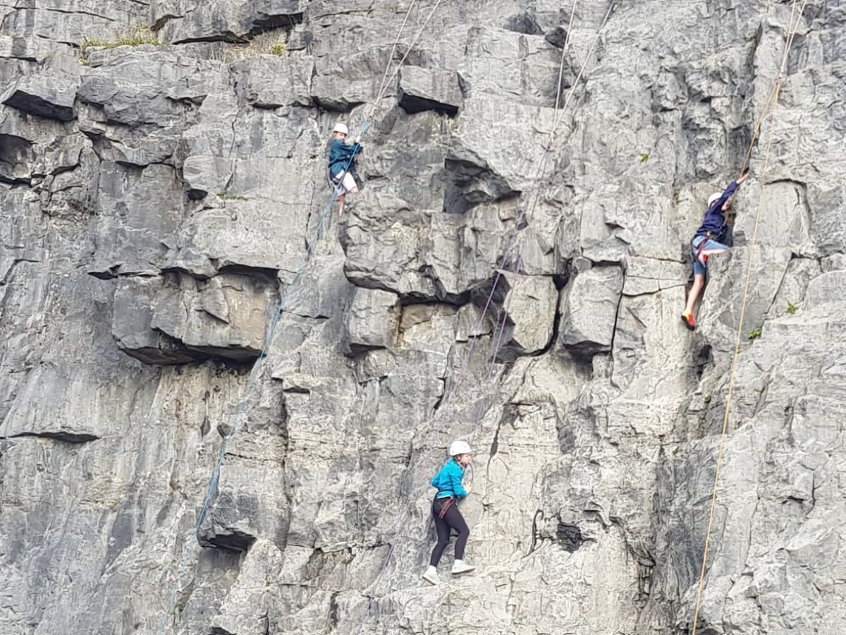 a group of people on a rock
