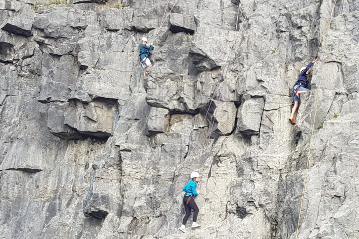 a group of people on a rock