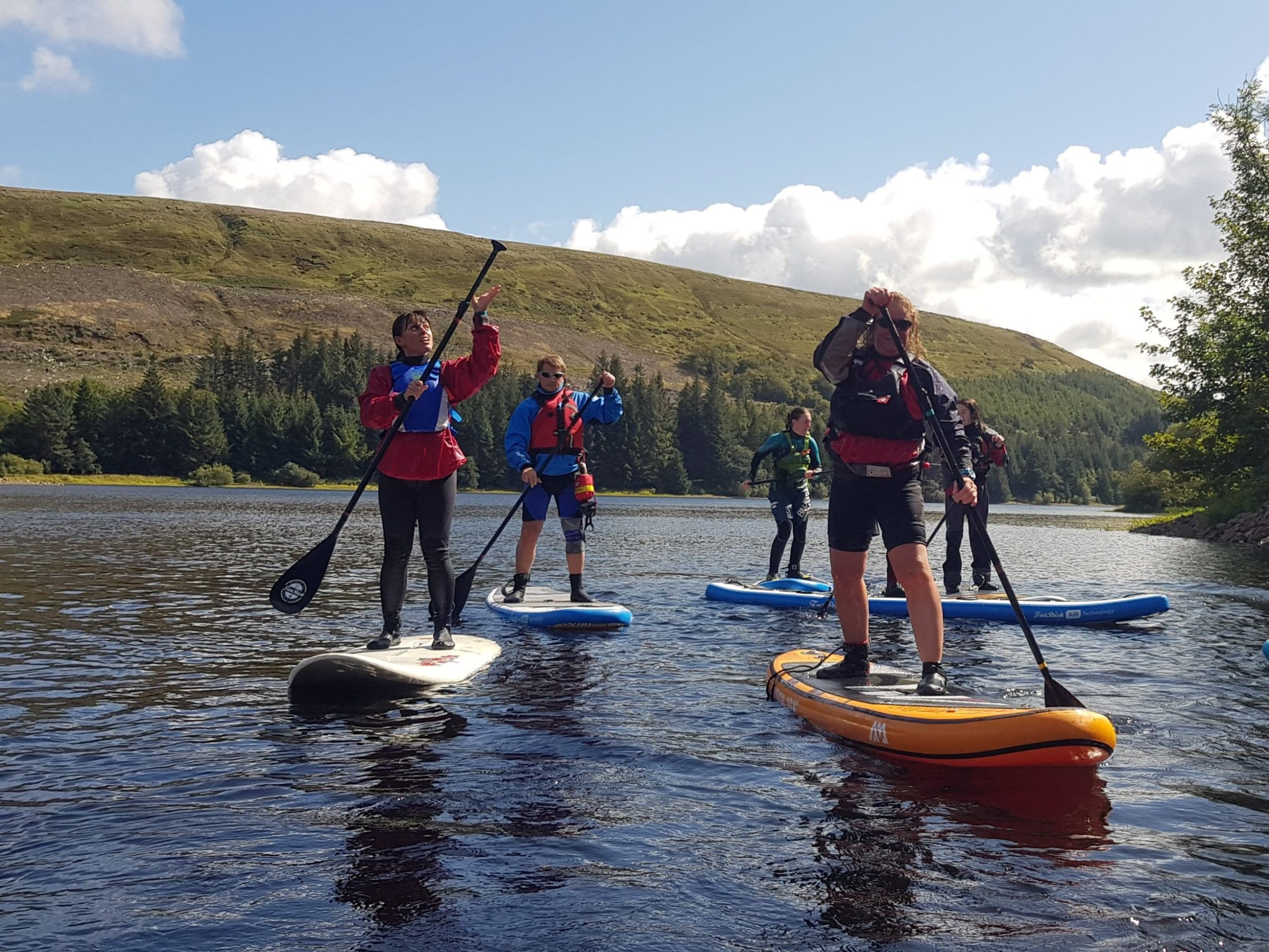 a group of people riding on the back of a boat in the water
