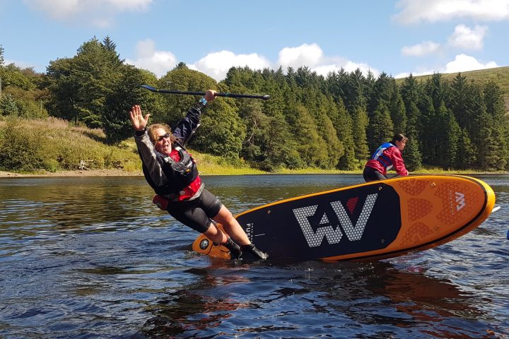 a man riding a board on a body of water