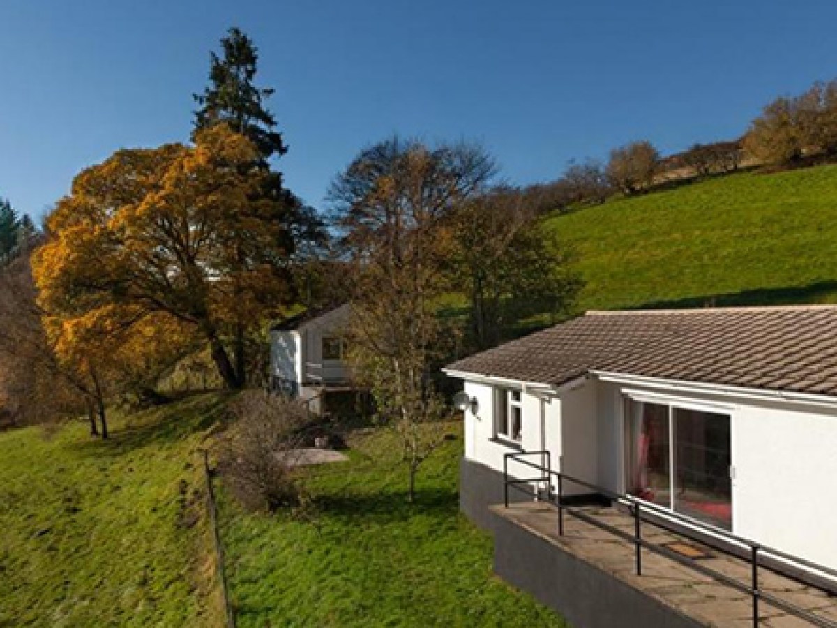 a small house on a grassy hill