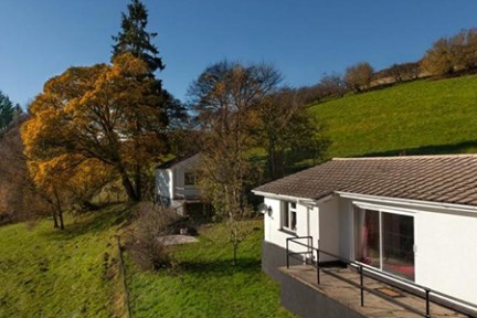 a small house on a grassy hill