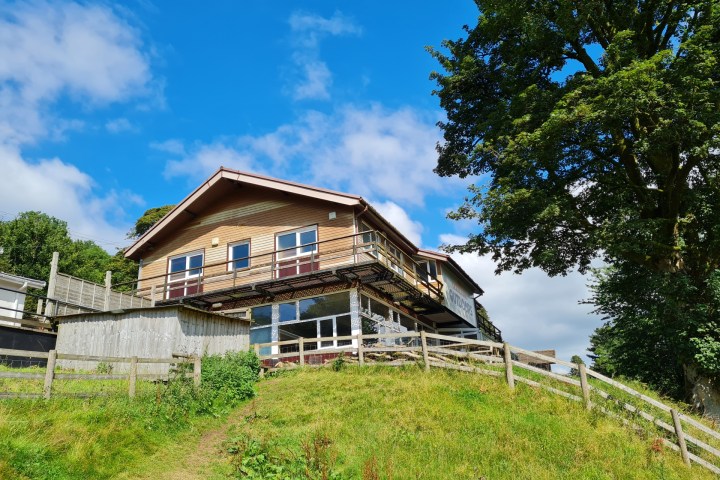 a house on a grassy hill