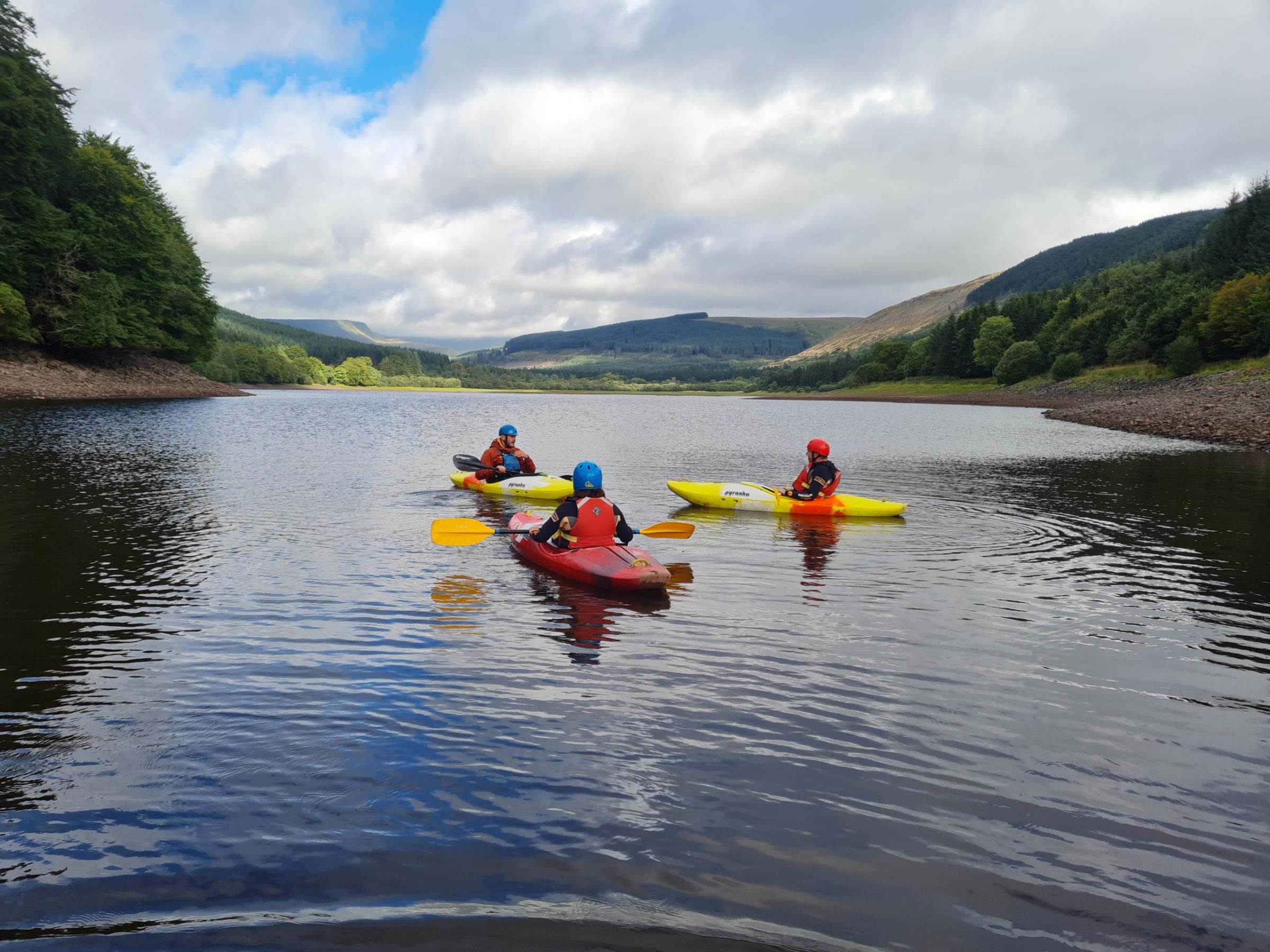 a group of people rowing a boat in a body of water