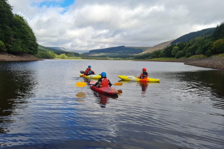 a group of people rowing a boat in a body of water