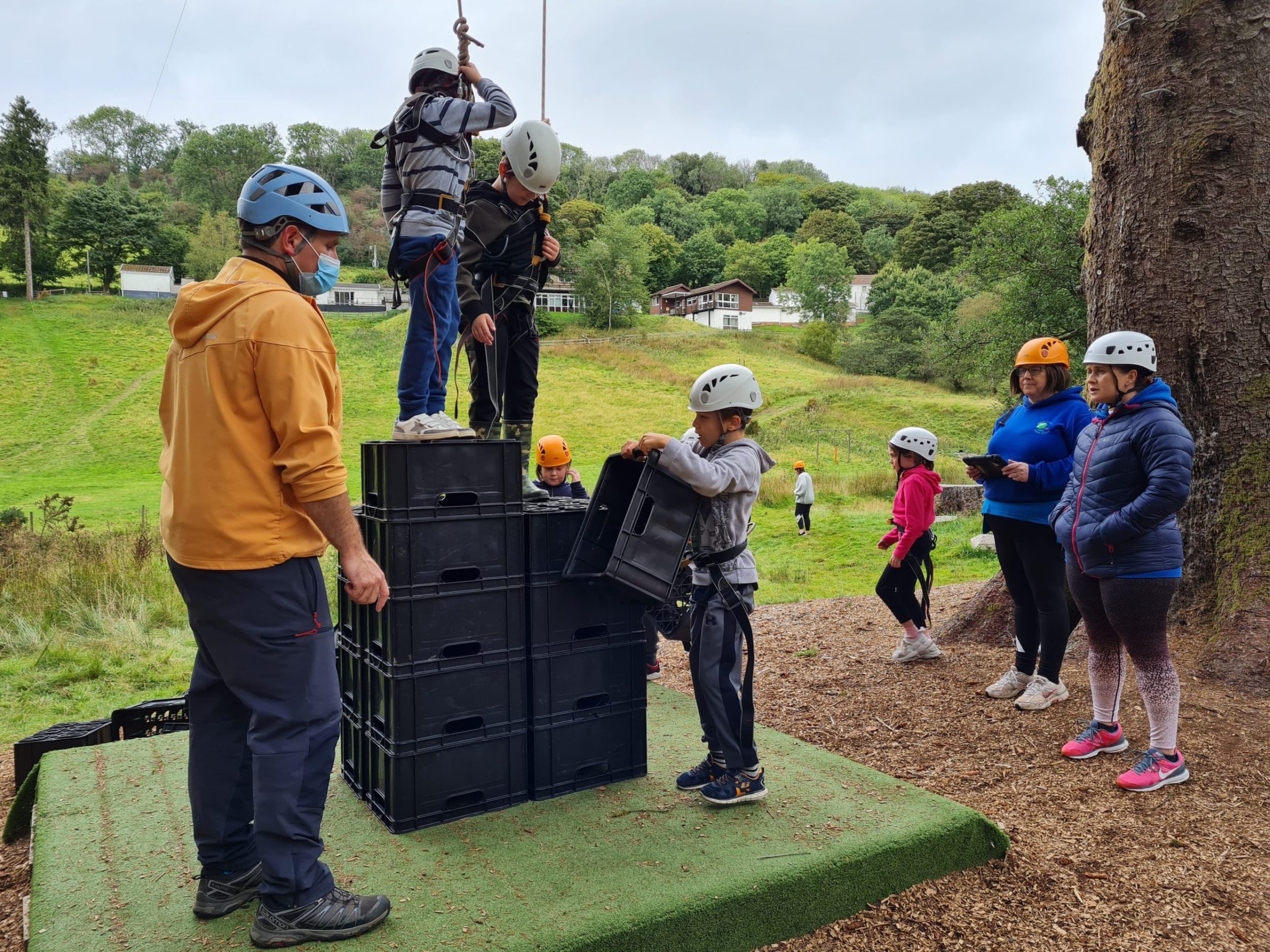 a group of people standing in the grass