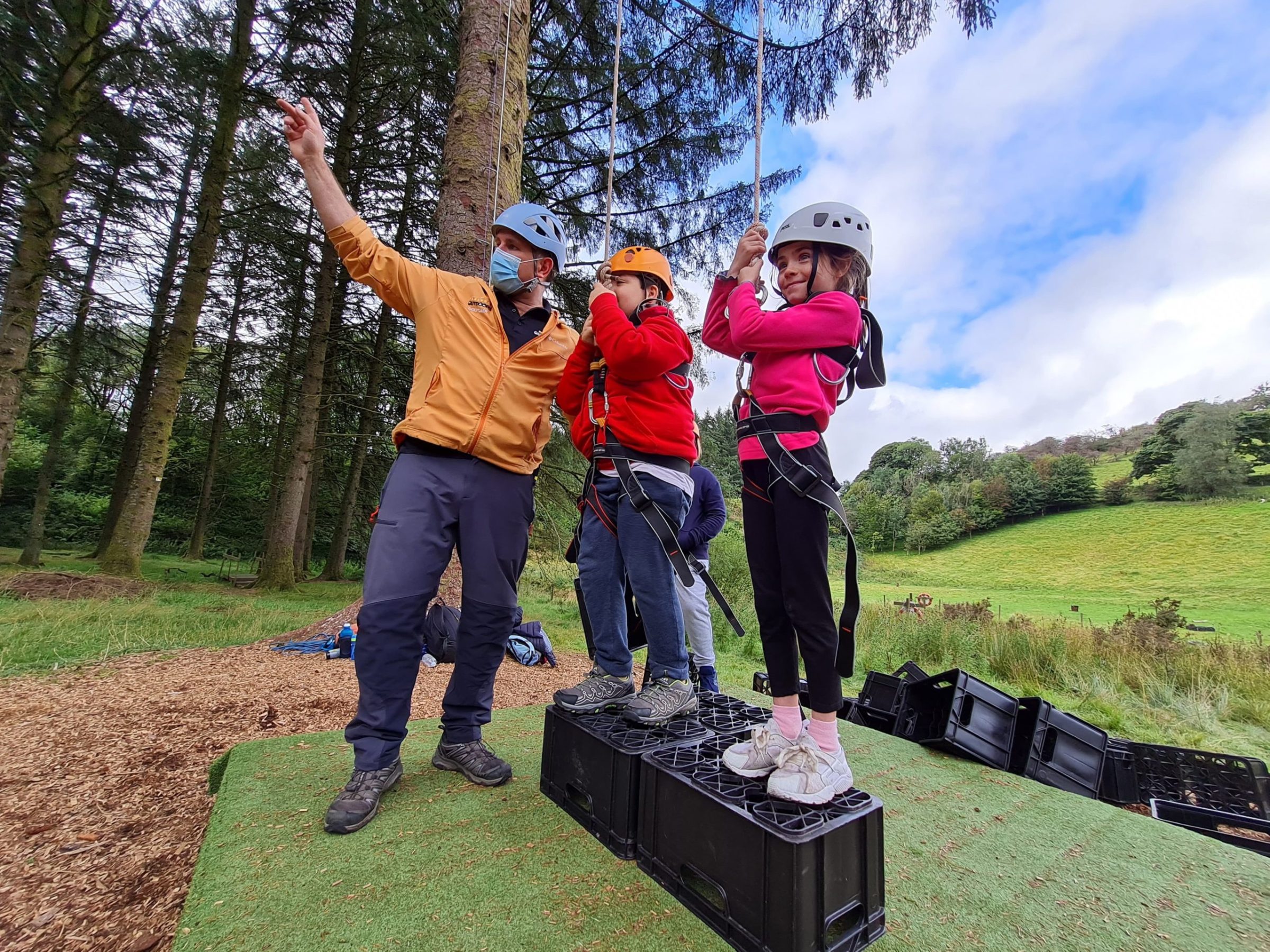 a group of people that are standing in the grass