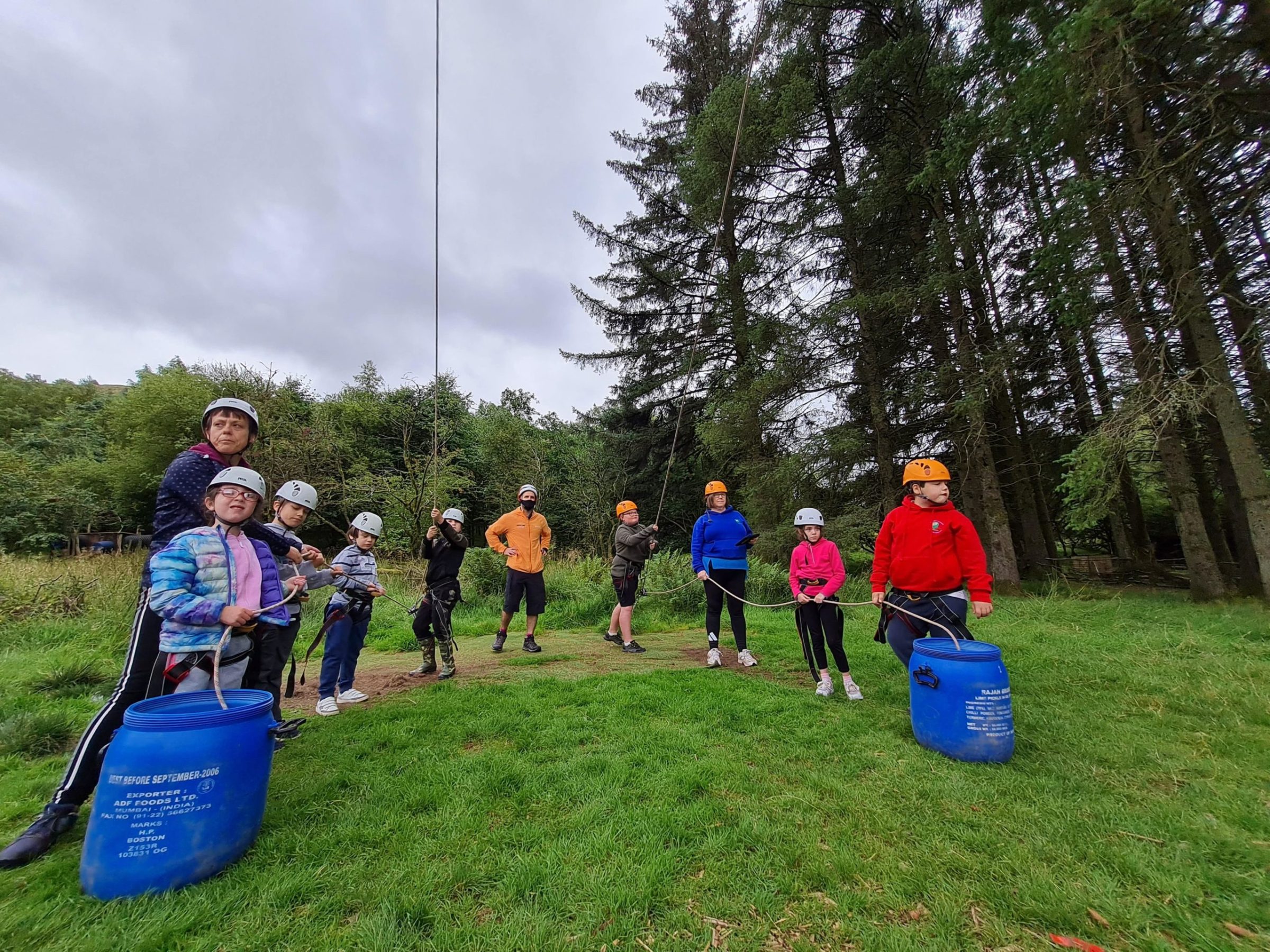 a group of people that are standing in the grass