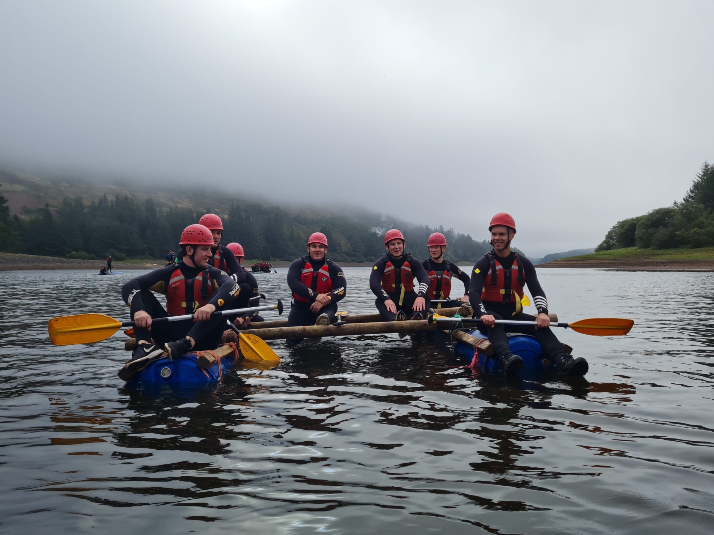 a group of people on a raft in a body of water