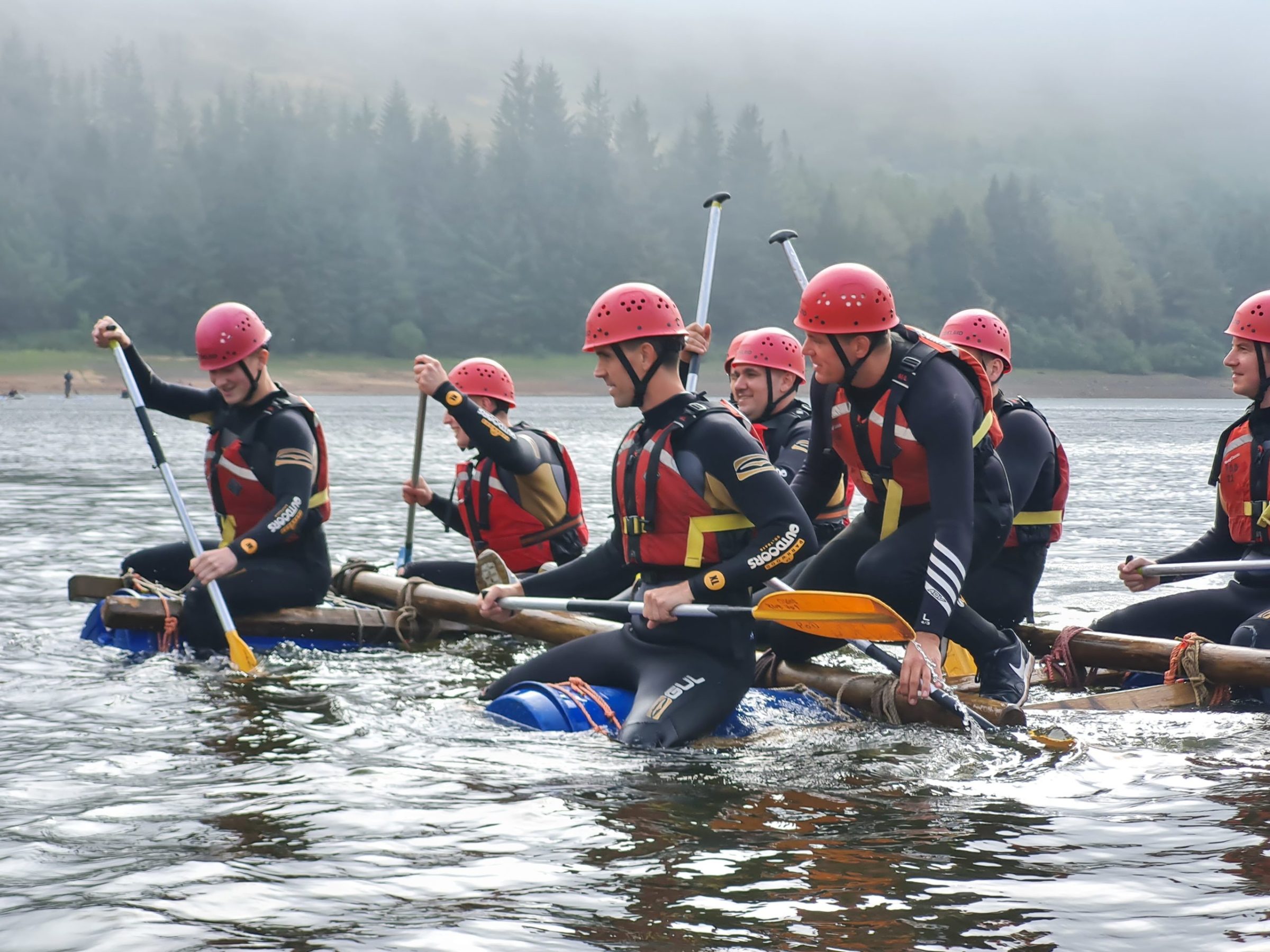 a group of people on a raft in the water