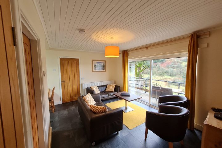 a living room filled with furniture and a large window