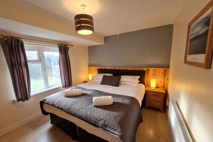 a bedroom with a bed and desk in a room