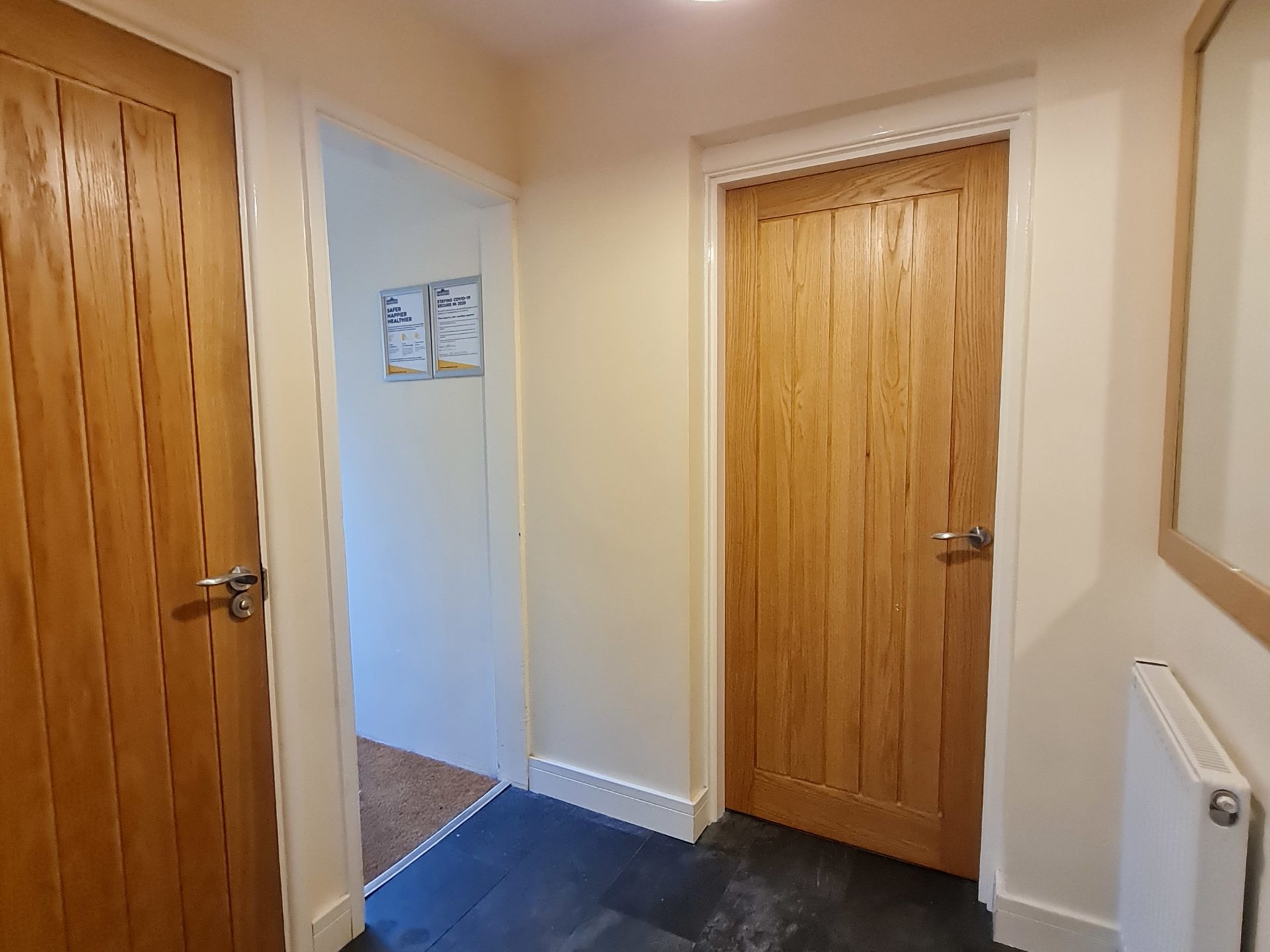 a bedroom with a wood floor