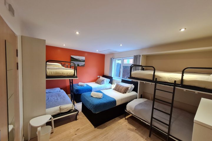 a bedroom with a bed and desk in a room