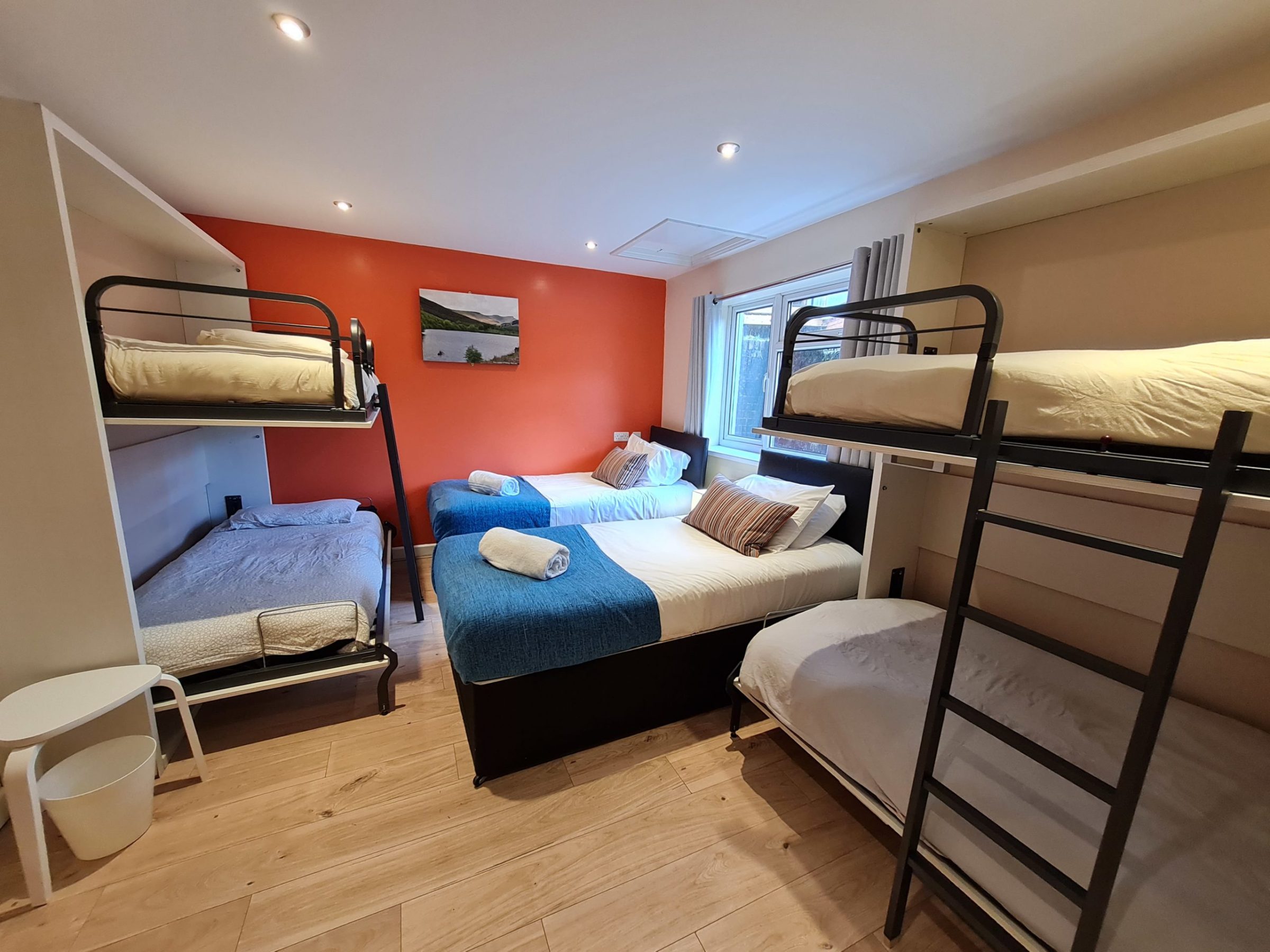 a bedroom with a bed and a chair in a room