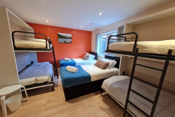 a bedroom with a bed and a chair in a room