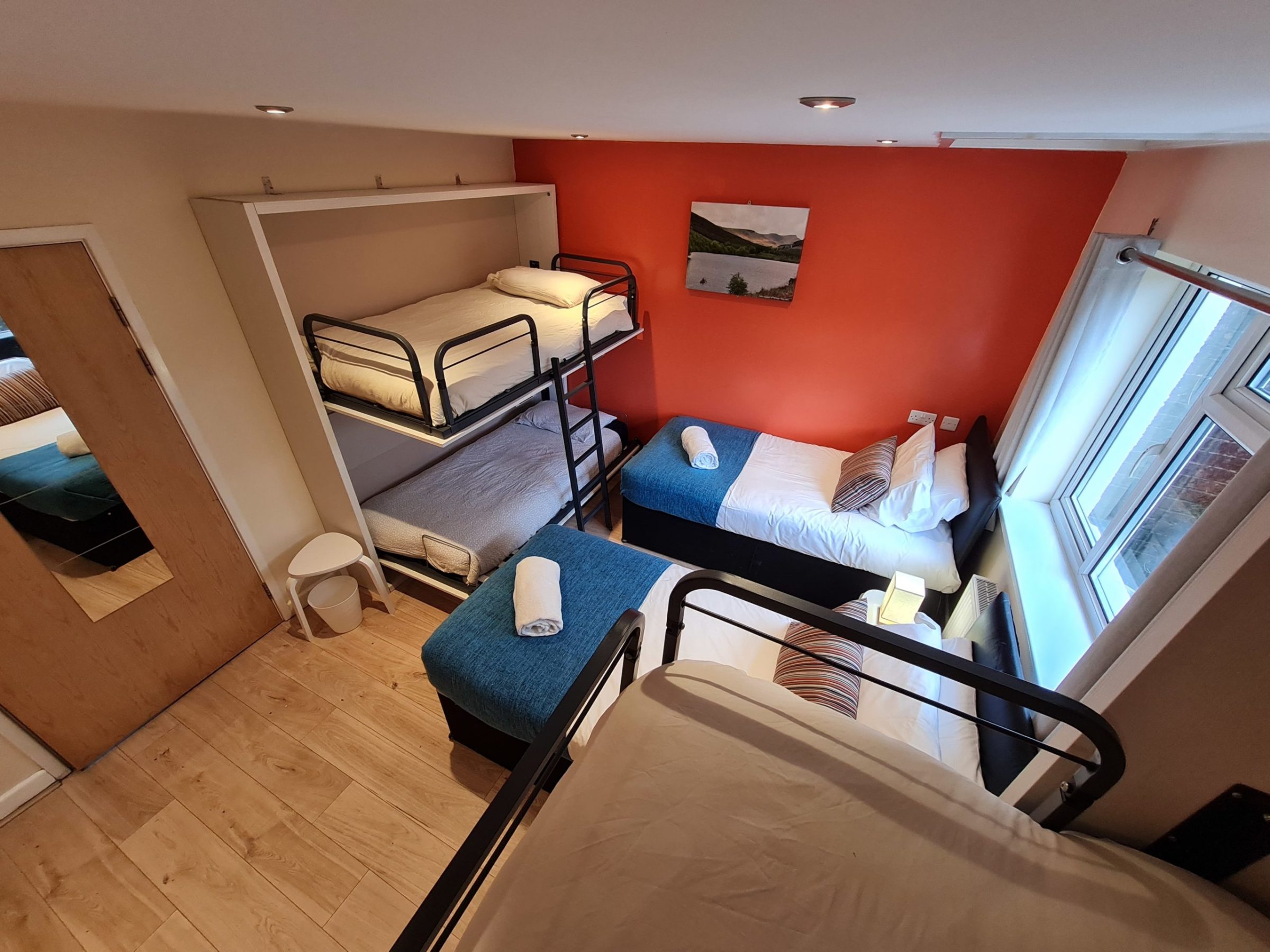 a bedroom with a bed and a chair in a room