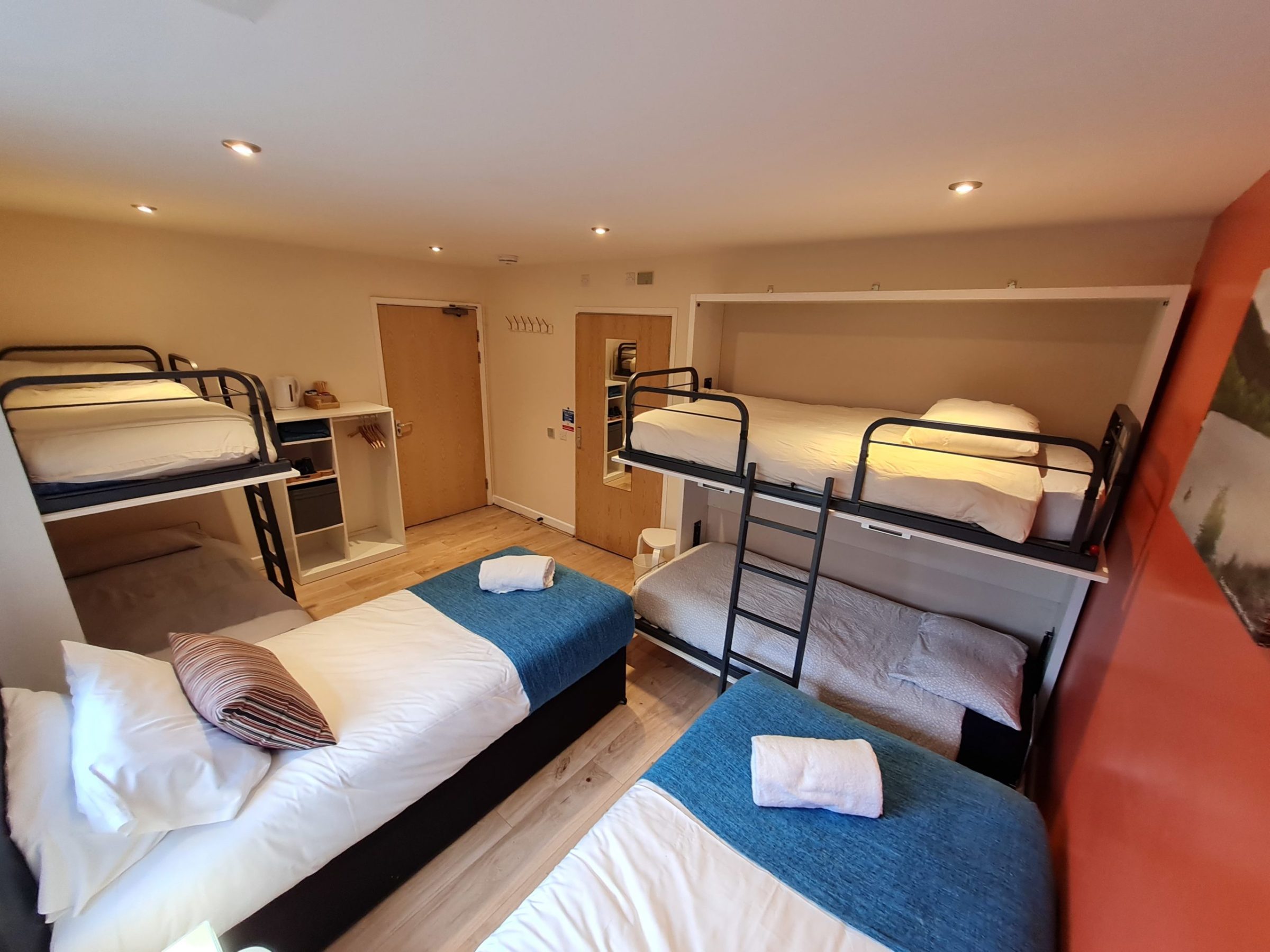 a bedroom with a bed and a chair in a room