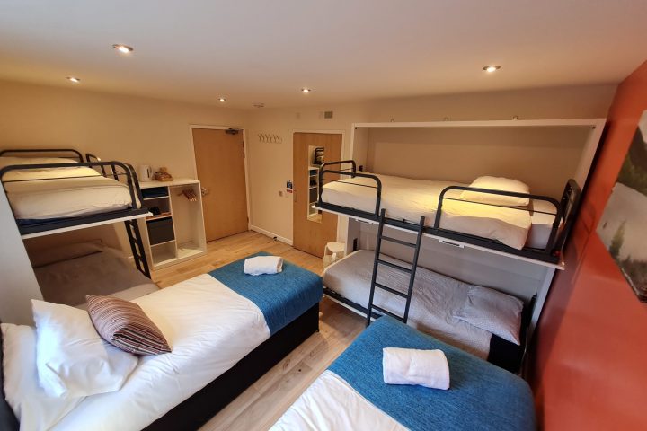 a bedroom with a bed and a chair in a room