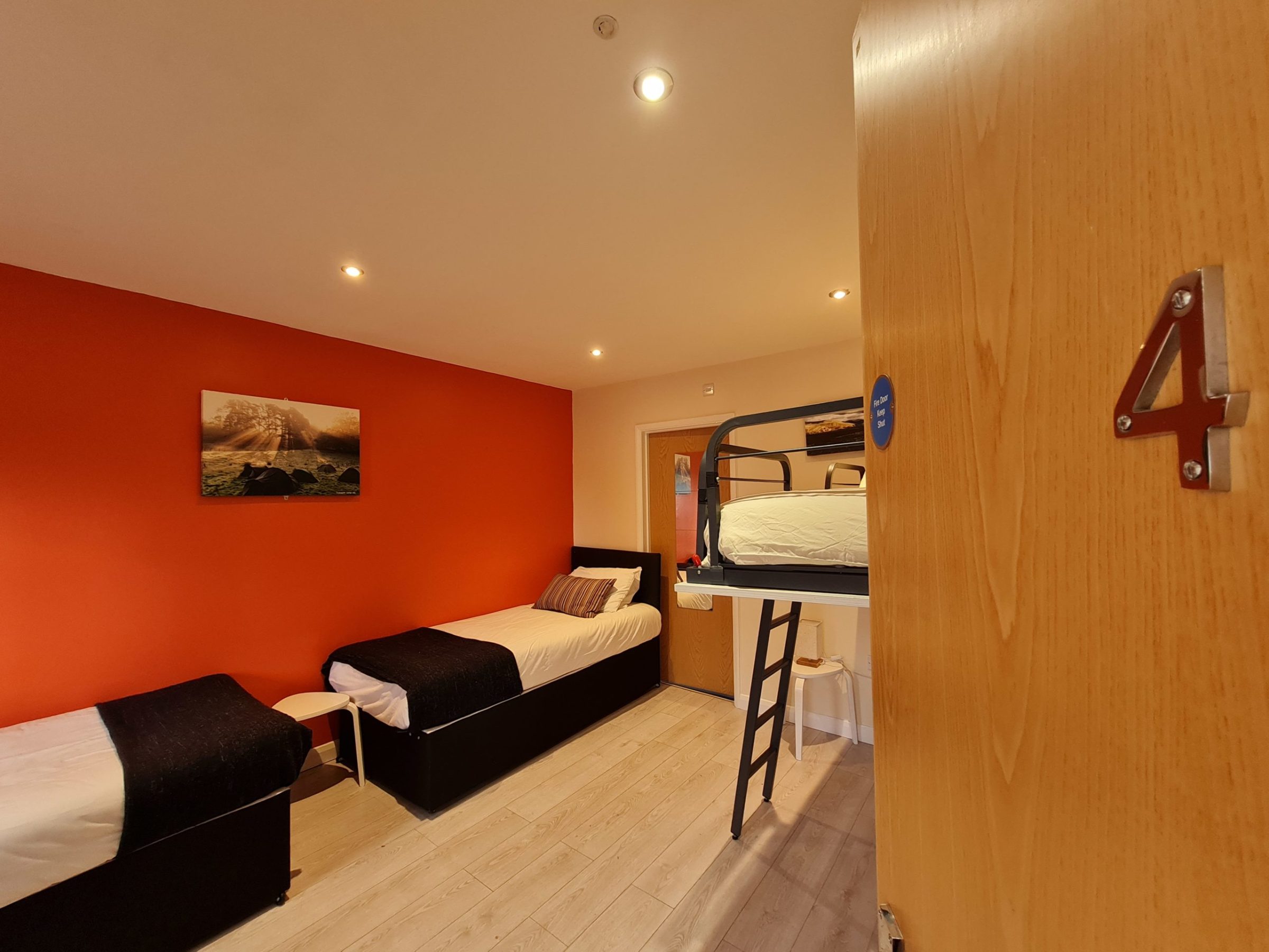 a bedroom with a bed and desk in a room