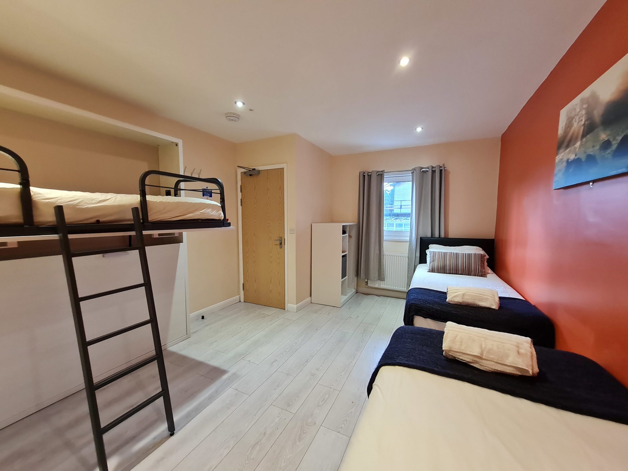 a bedroom with a bed and desk in a room