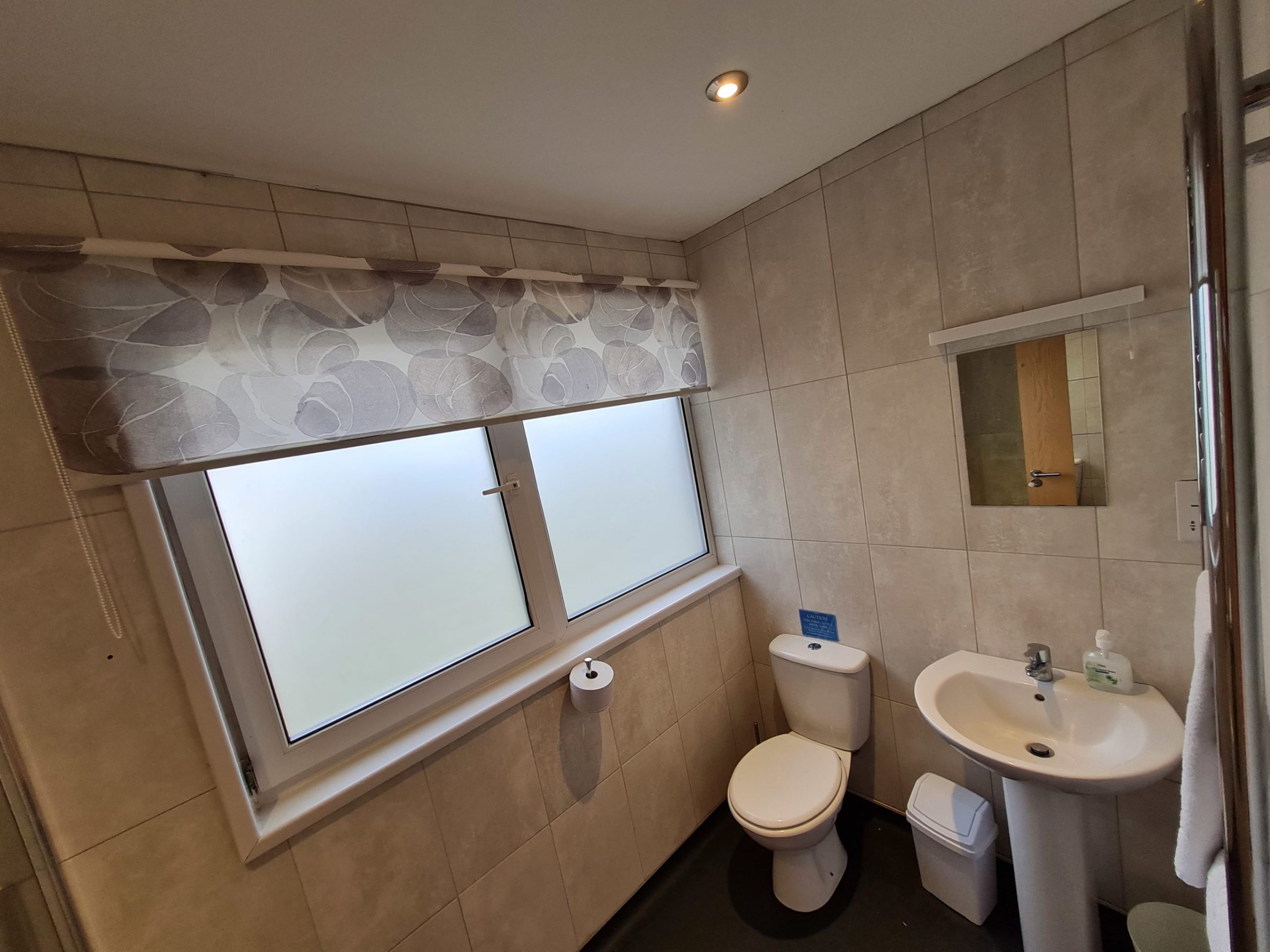 a room with a sink and a mirror