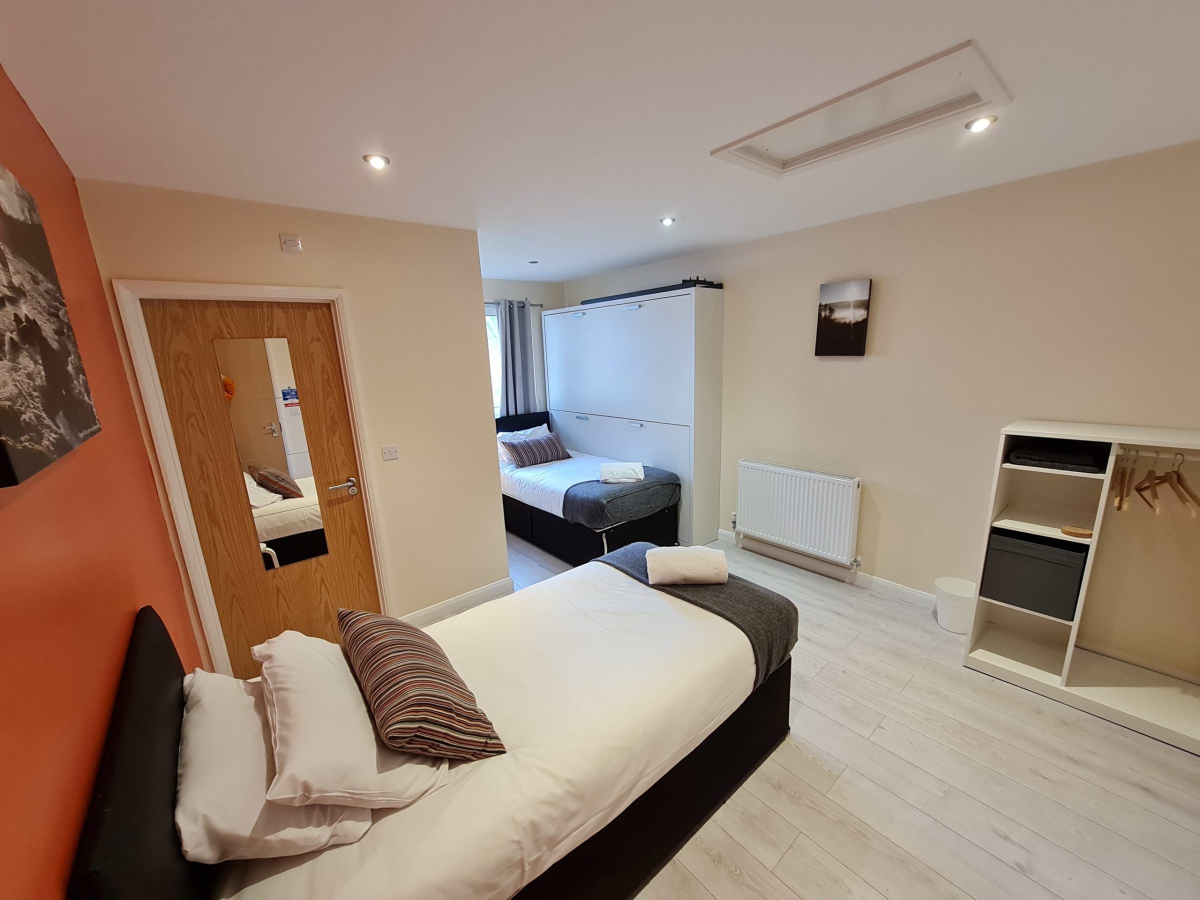 a bedroom with a view of a living room