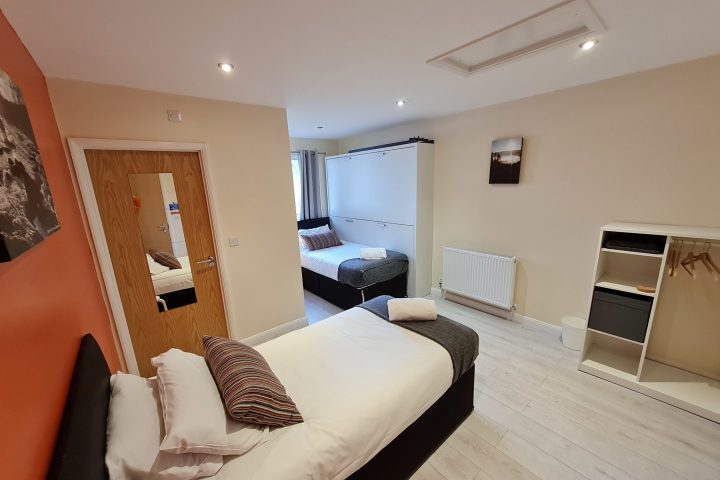 a bedroom with a view of a living room