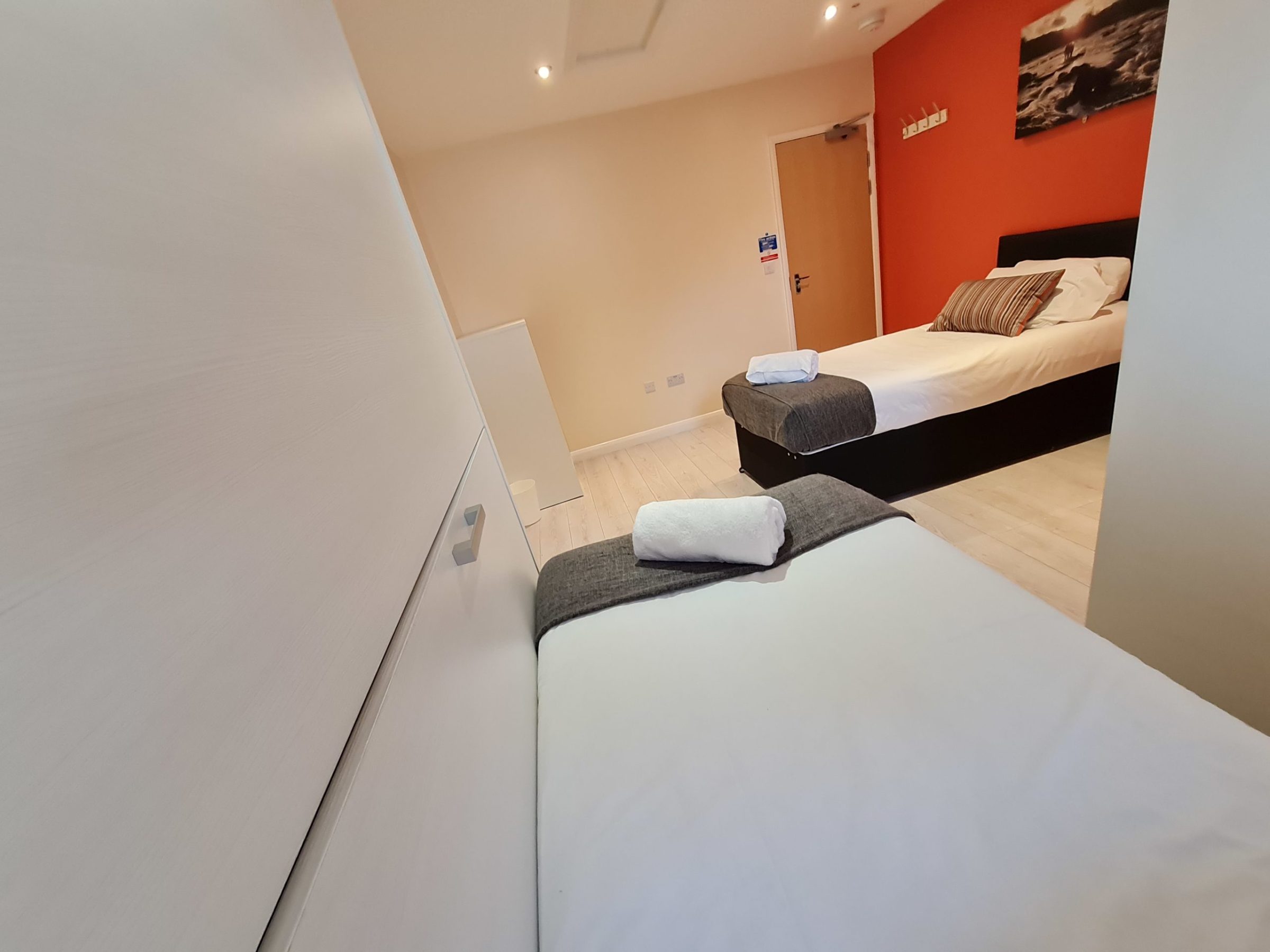 a bedroom with a bed and a mirror