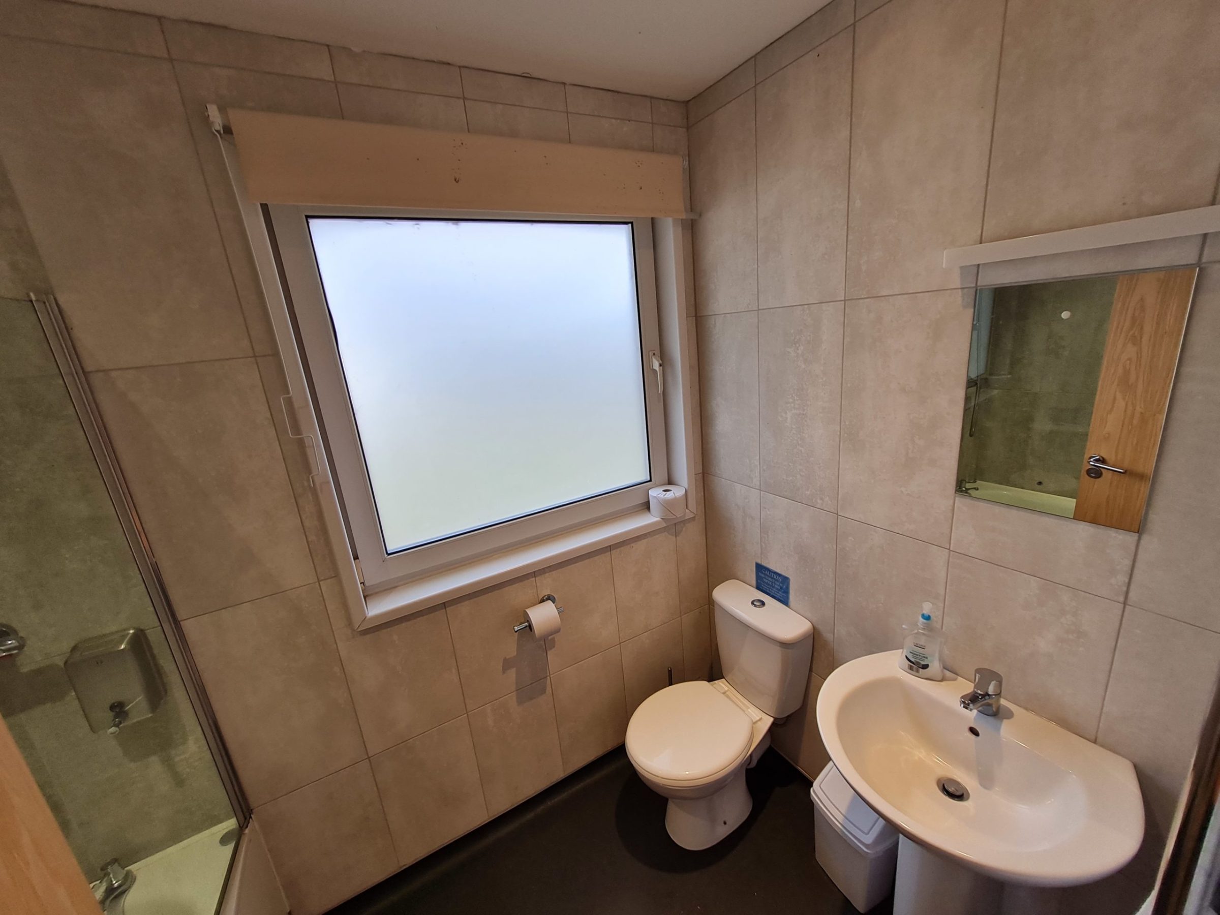 a room with a sink and a mirror