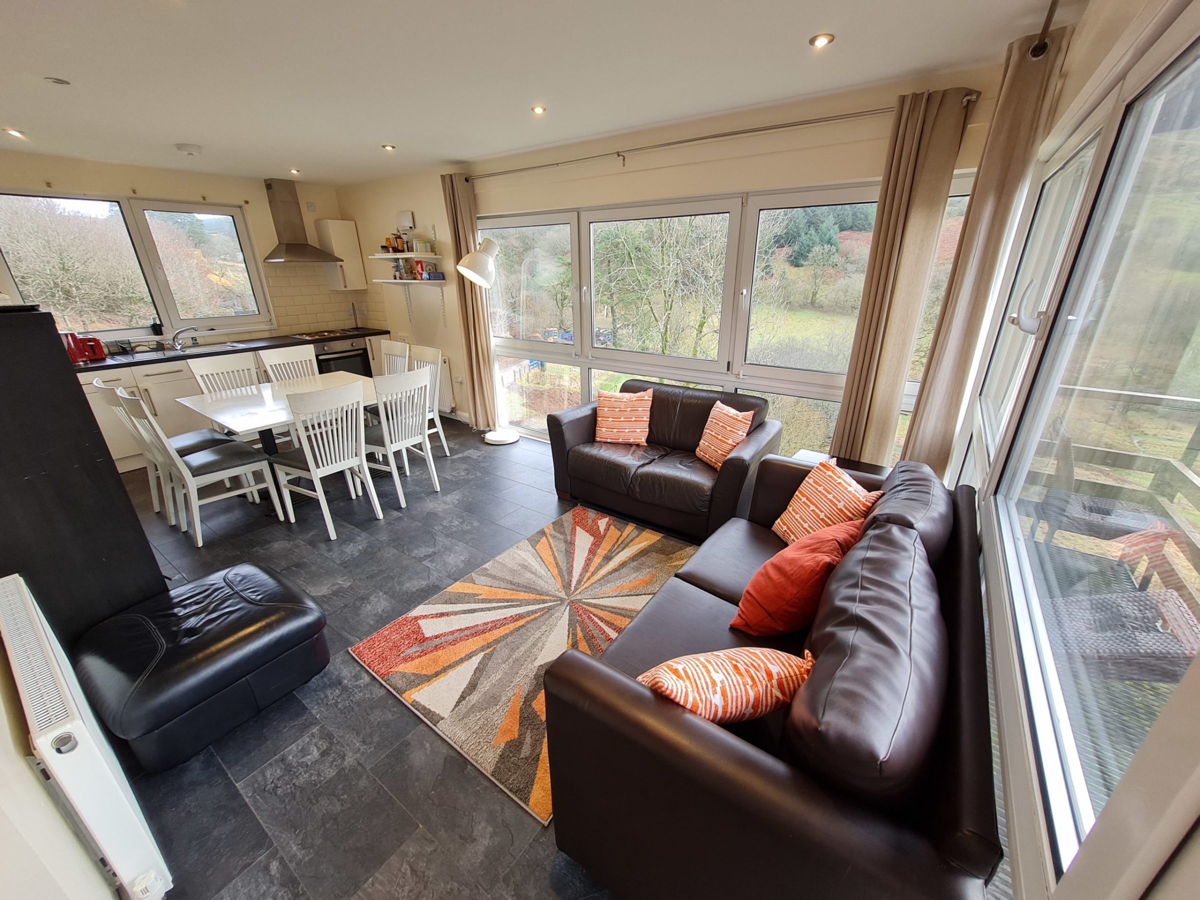 a living room filled with furniture and a large window