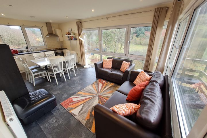 a living room filled with furniture and a large window