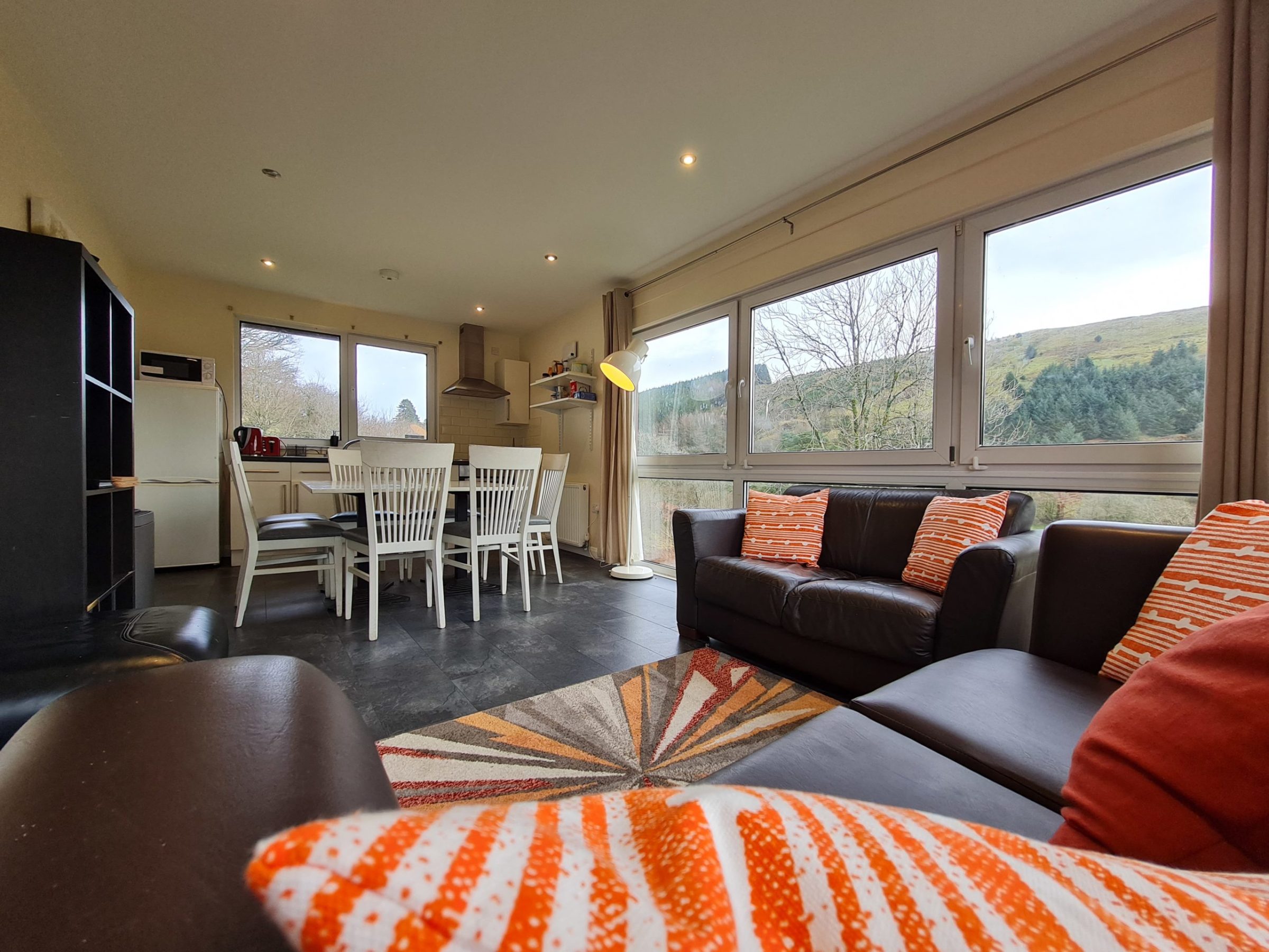 a view of a living room filled with furniture and a large window