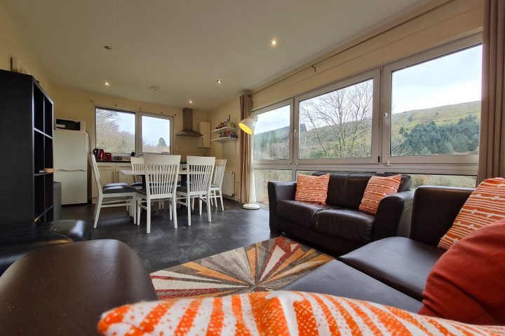 a view of a living room filled with furniture and a large window