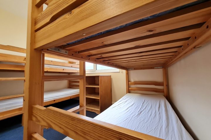 a bedroom with a bed and chair