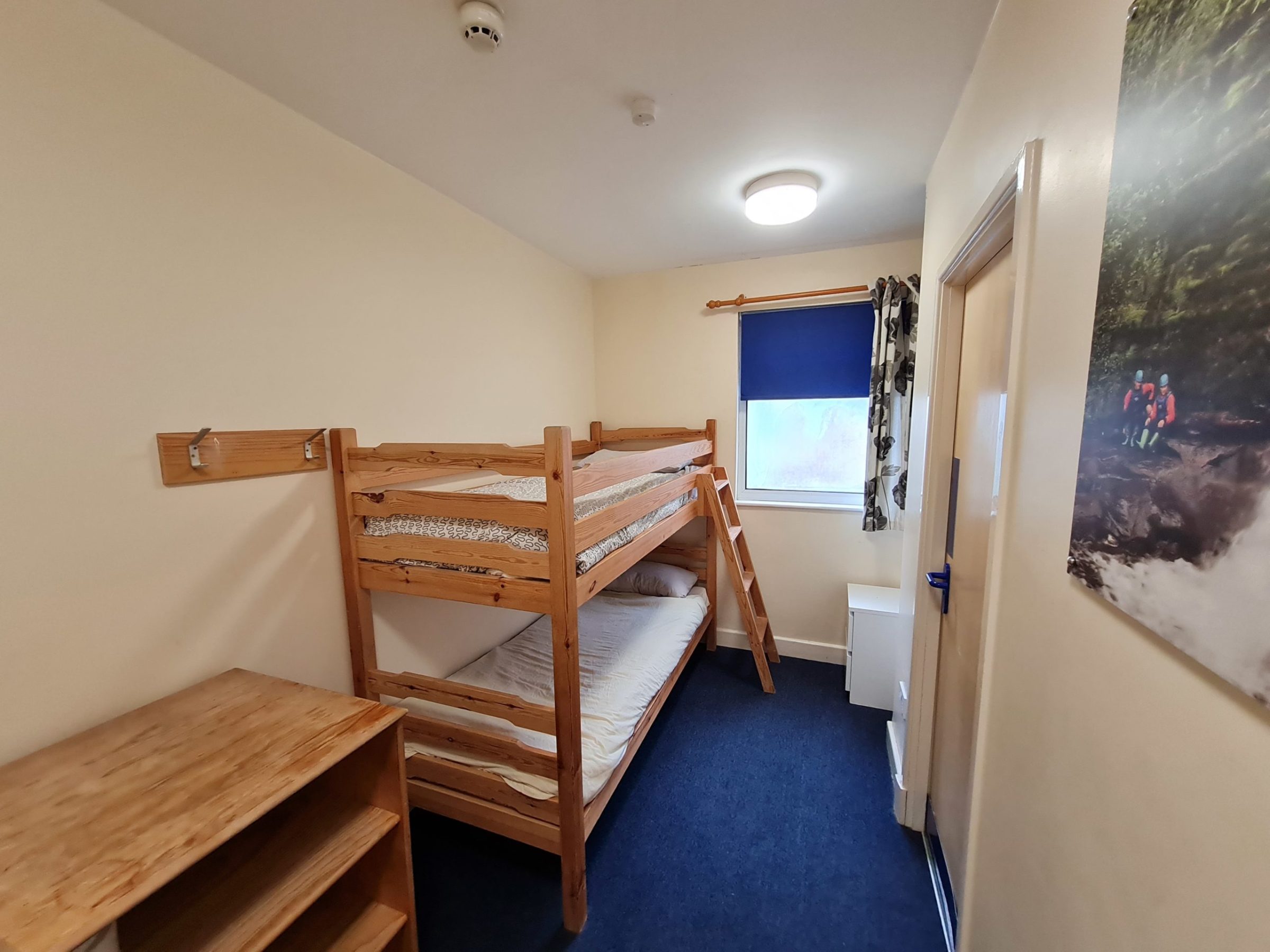 a bedroom with a bed and a chair in a room