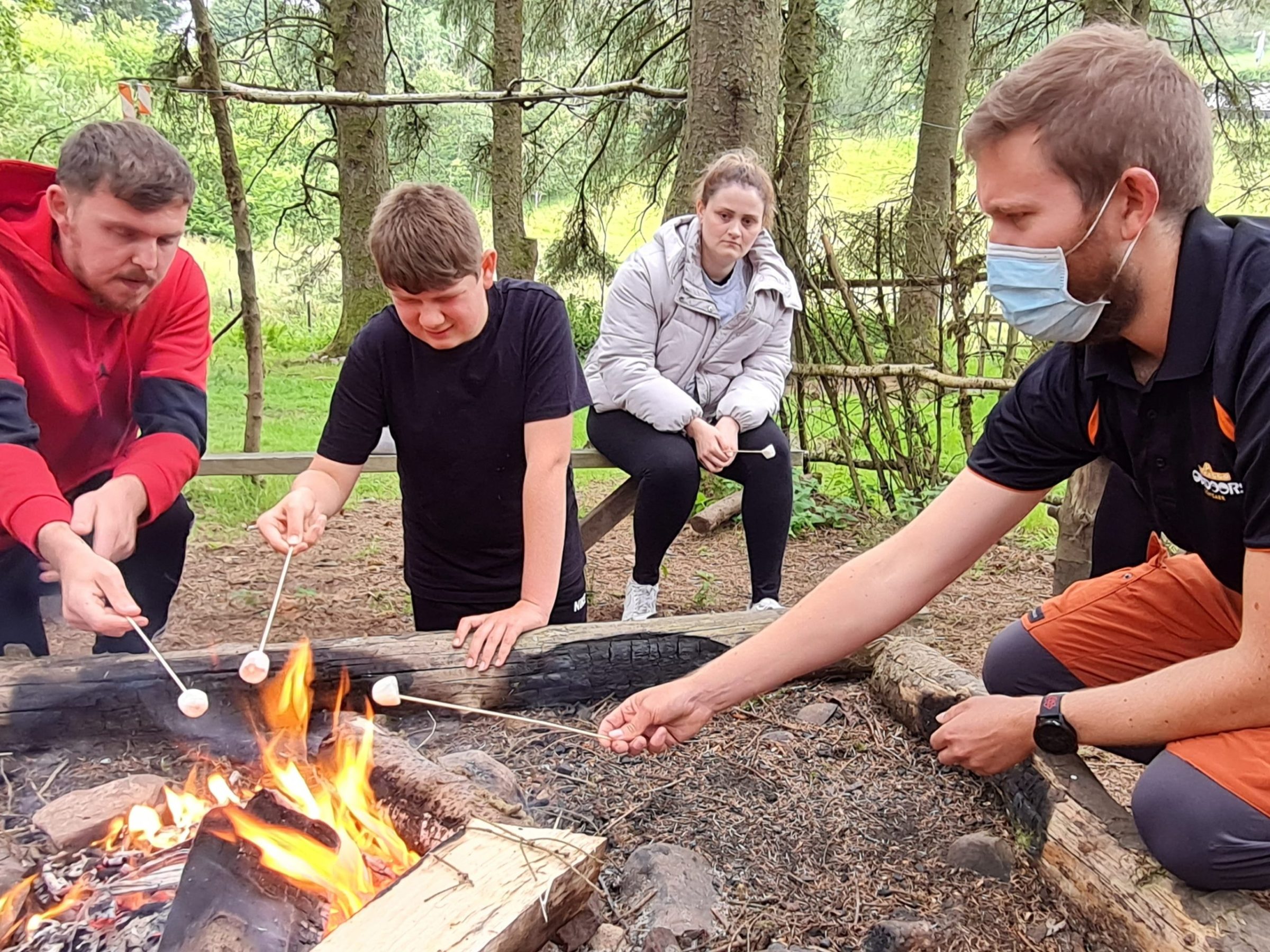 a group of people sitting on a grill