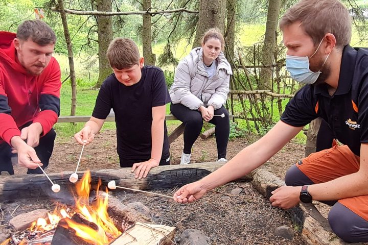 a group of people sitting on a grill