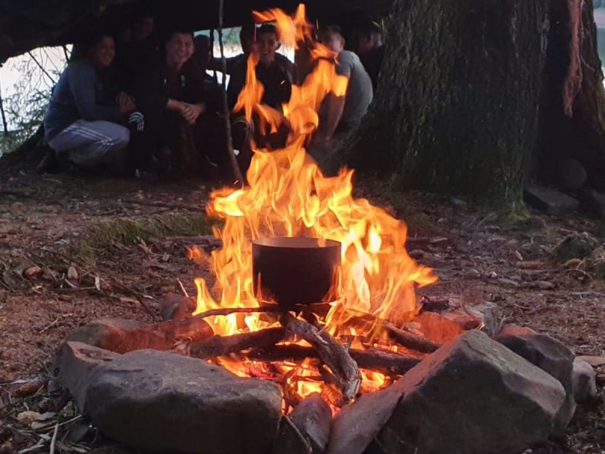 a group of people sitting around a fire