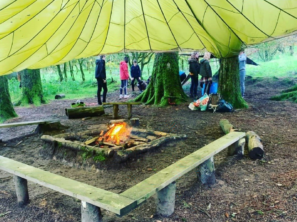 a group of people sitting in a tent