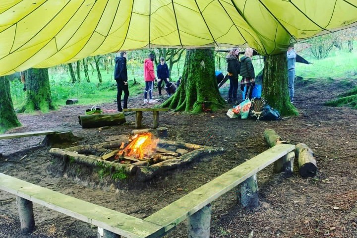 a group of people sitting in a tent
