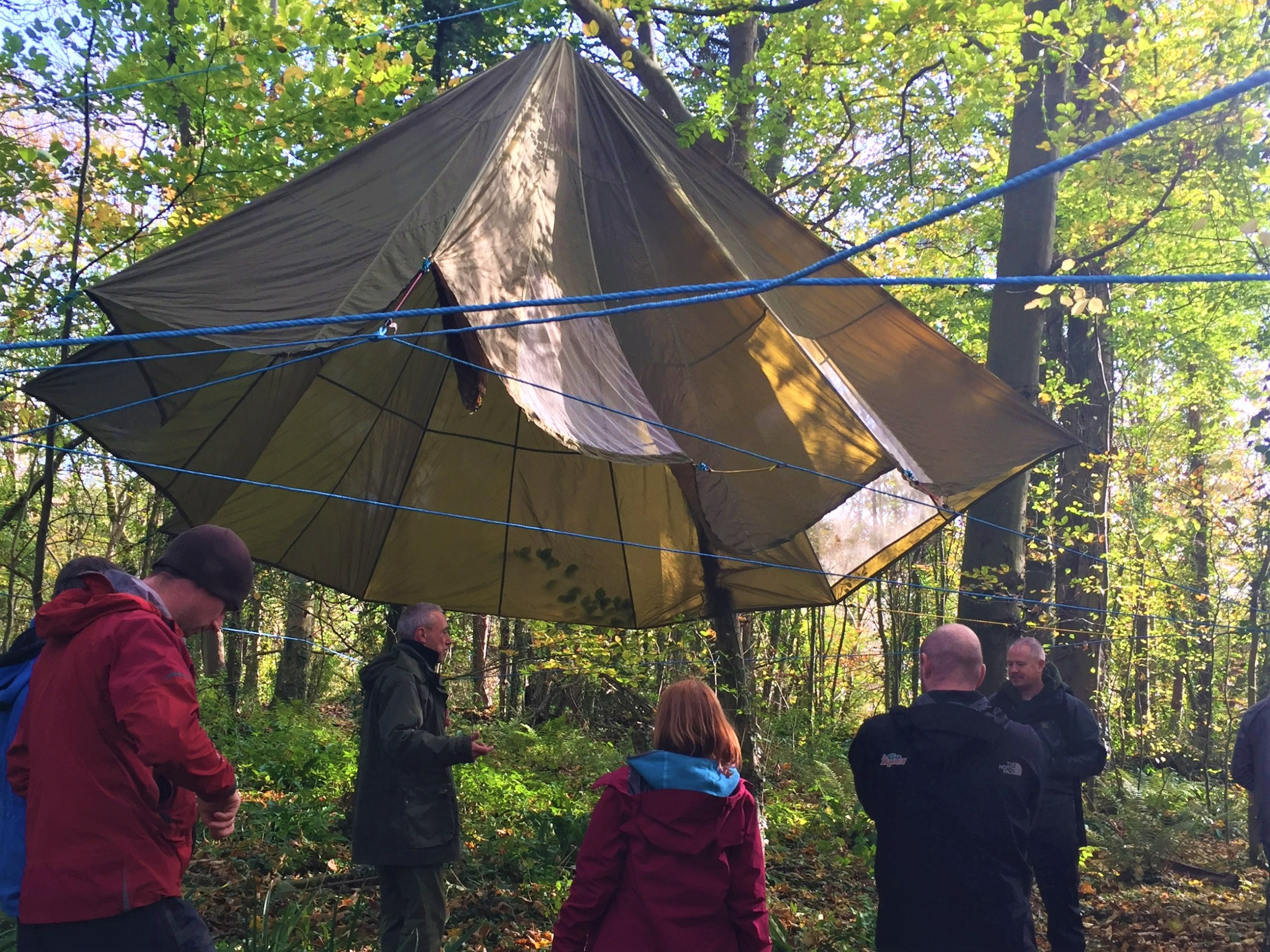 a group of people standing next to an umbrella
