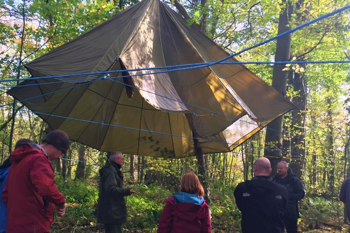 a group of people standing next to an umbrella