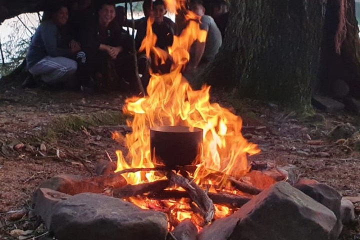 a group of people sitting around a fire