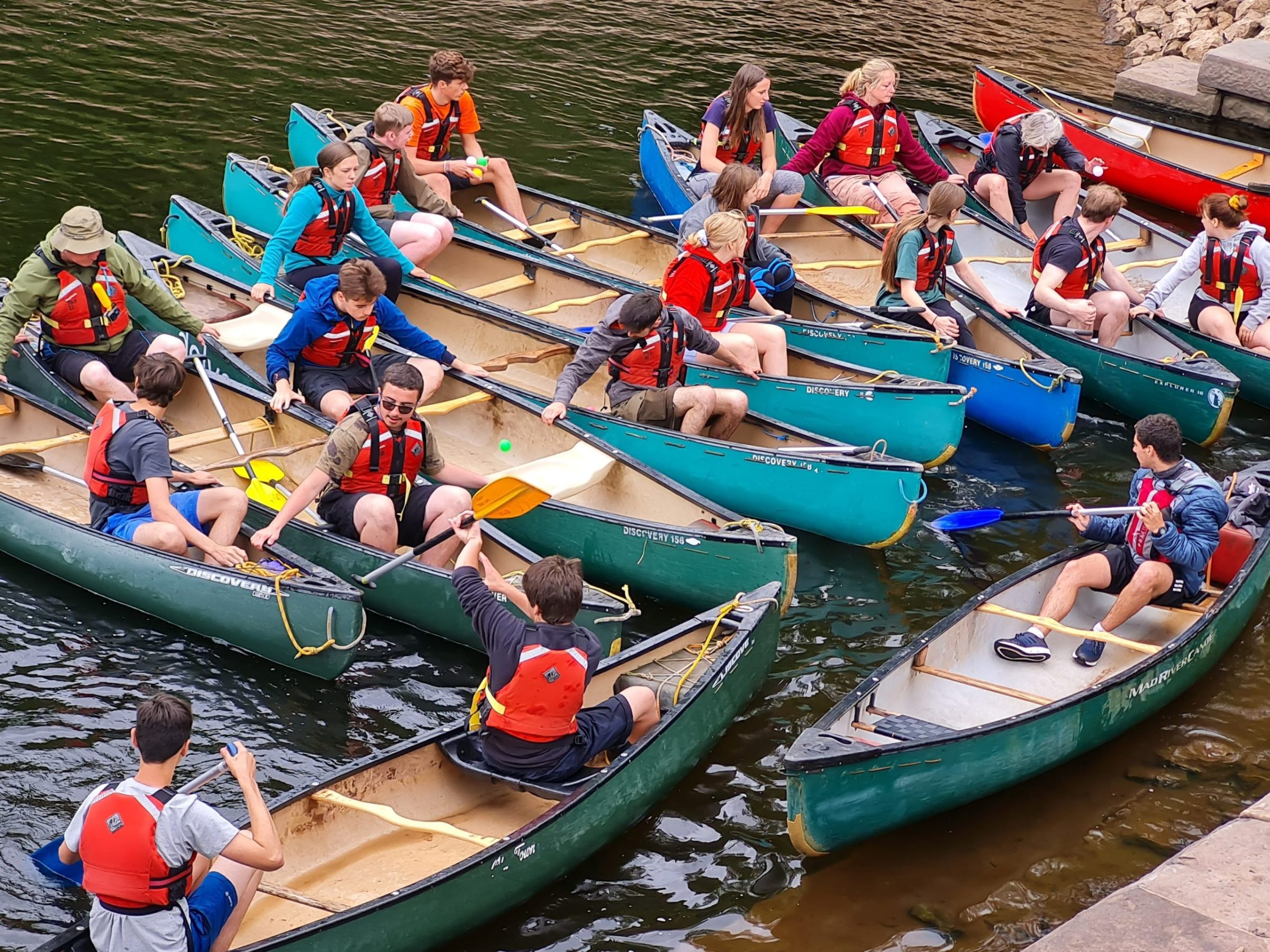 a group of people riding on the back of a boat