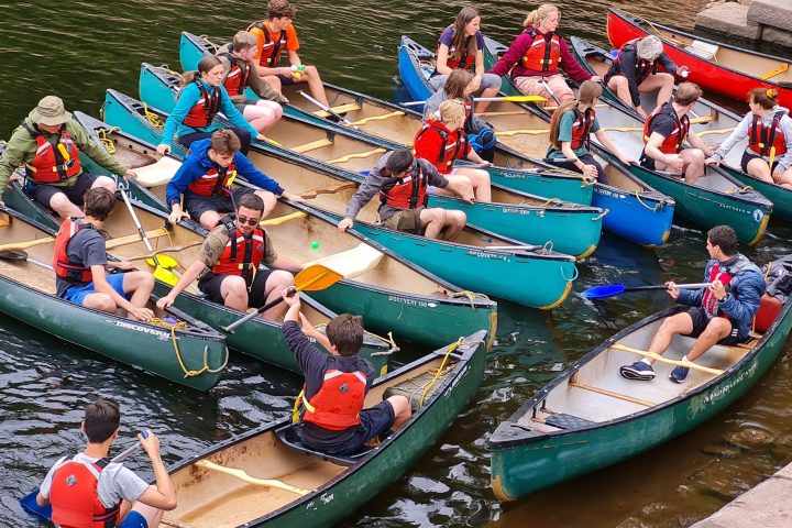 a group of people riding on the back of a boat