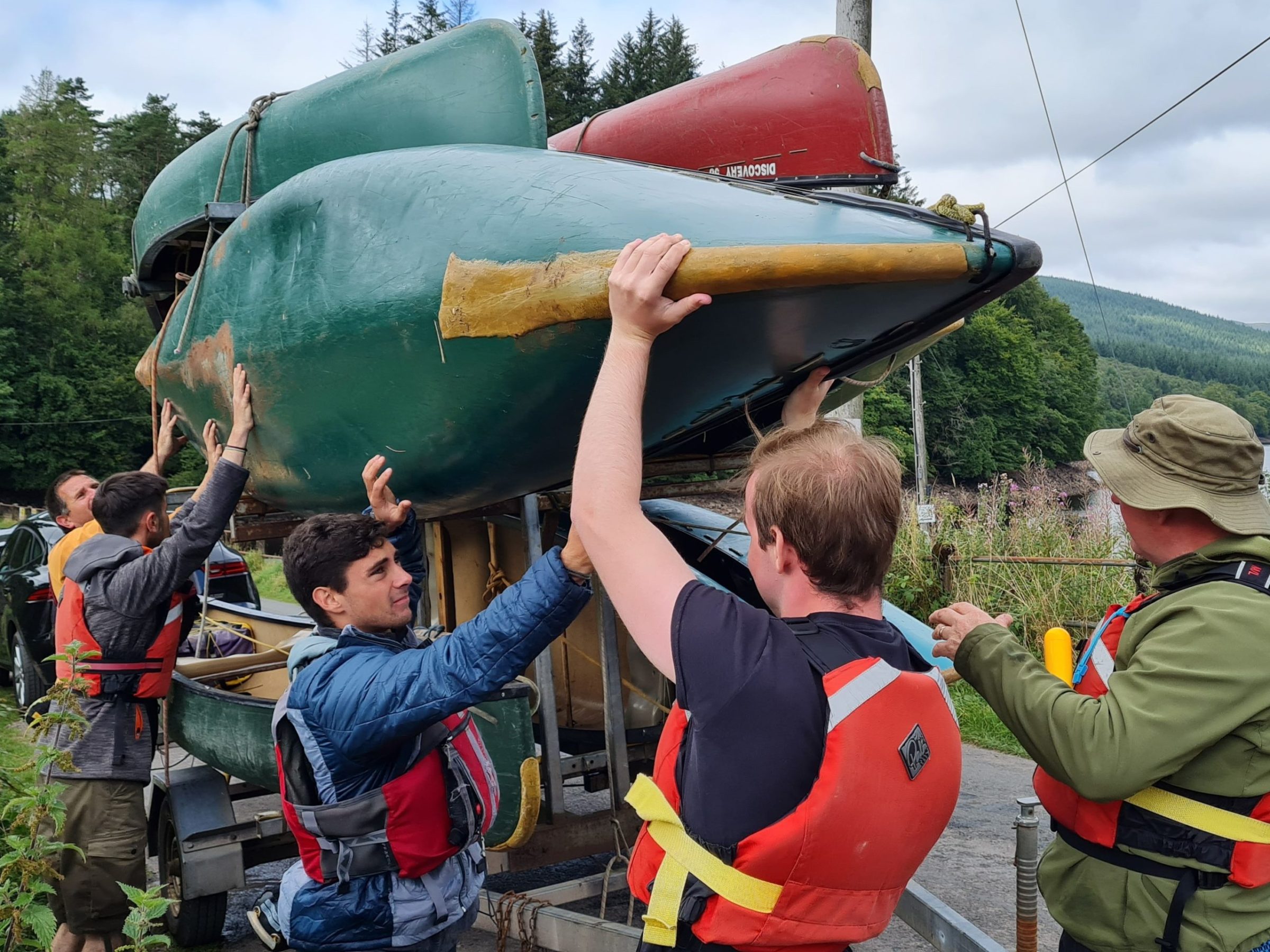 a group of people standing around a plane
