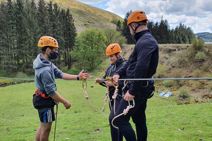 a man and a little boy that is holding a bat on a field