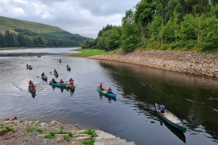 a group of people riding skis on a body of water