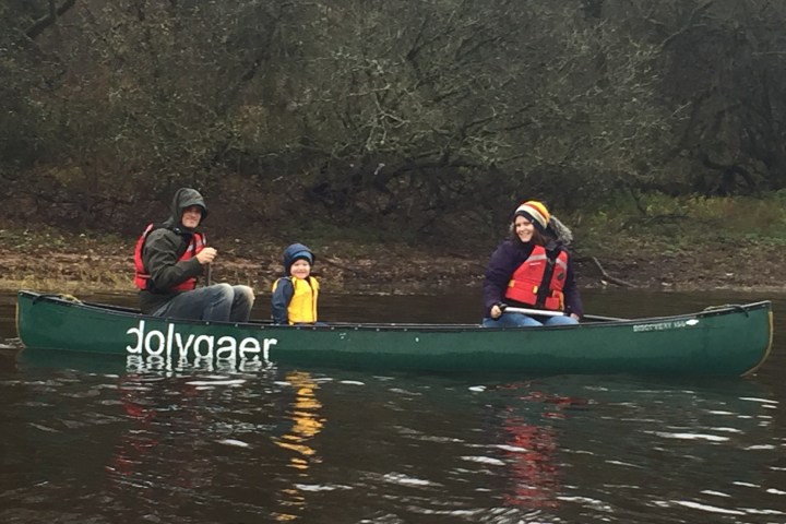 a group of people riding on the back of a boat